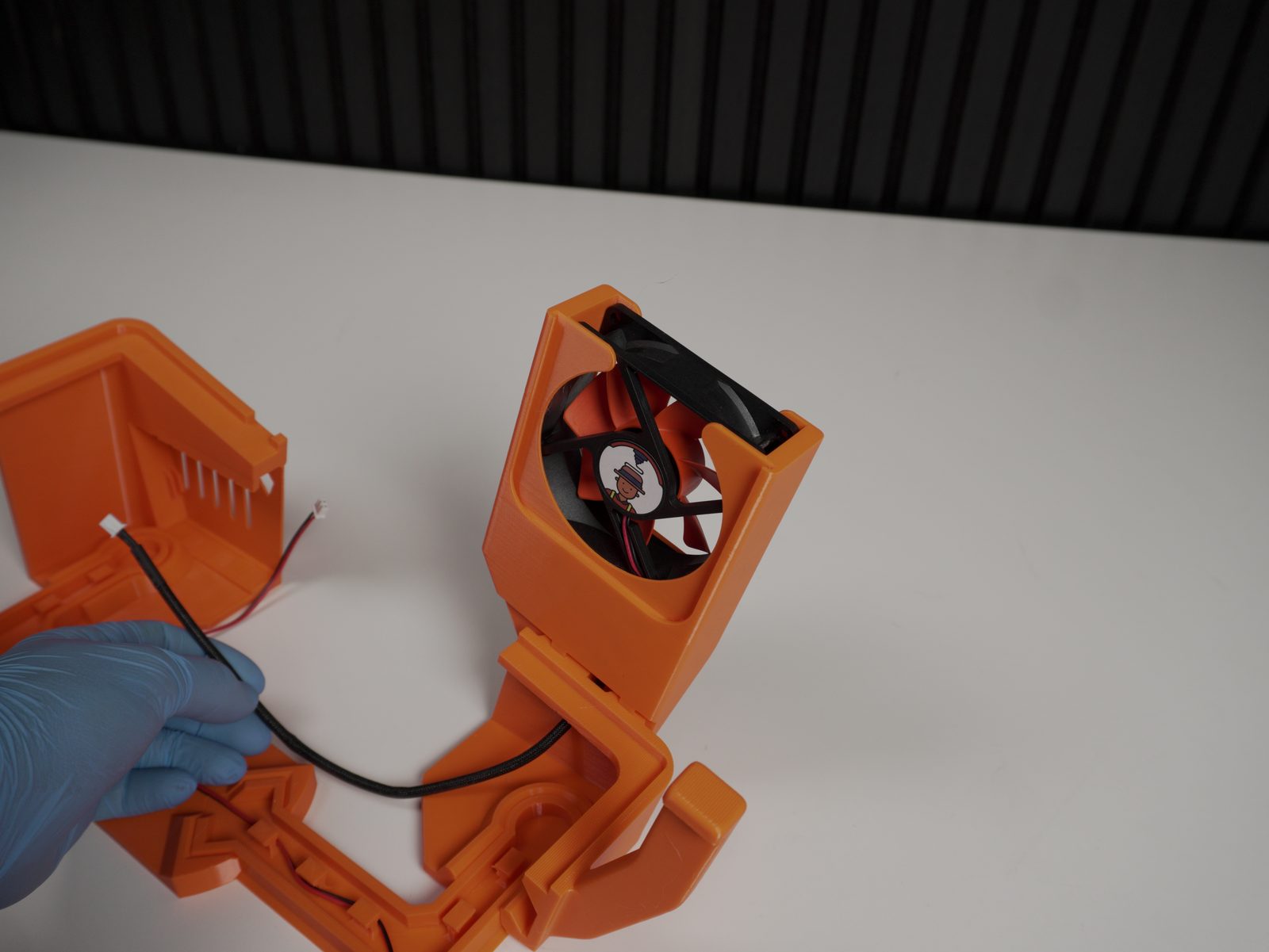Fan cable routed through opening