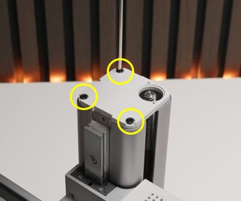 Grey lid lifted, three screws on the top edge highlighted for removal