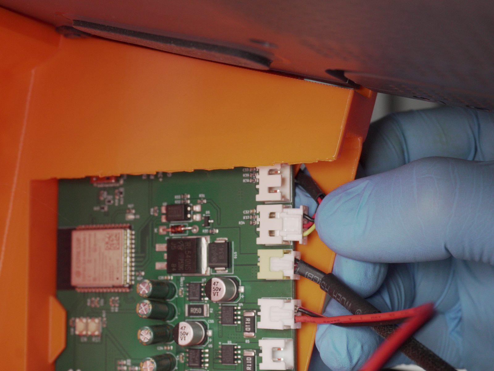 Connecting the AMS cable to the FarmBoard's AMS port inside the housing