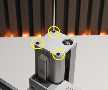 Grey lid lifted, three screws on the top edge highlighted for removal