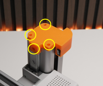 Orange limit-switch assembly mounted on the printer with four mounting points highlighted