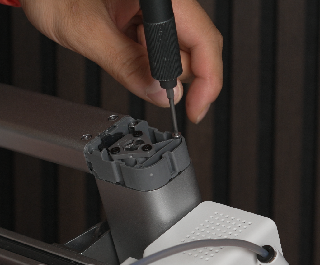 Screws being removed with the two screw positions highlighted