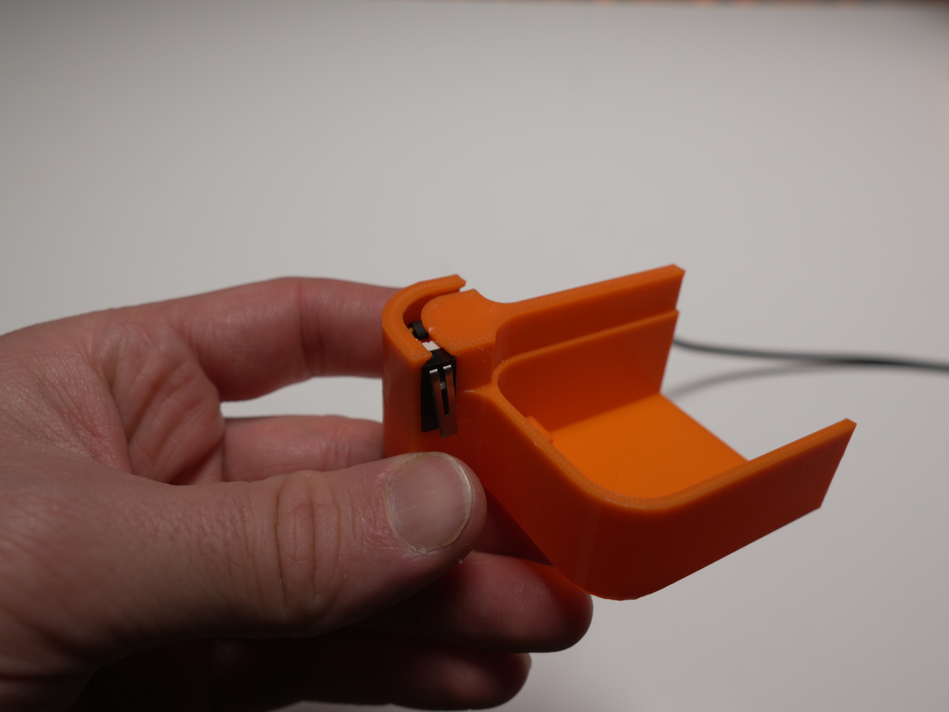 Limit switch seated into the orange printed holder with the extension cable attached