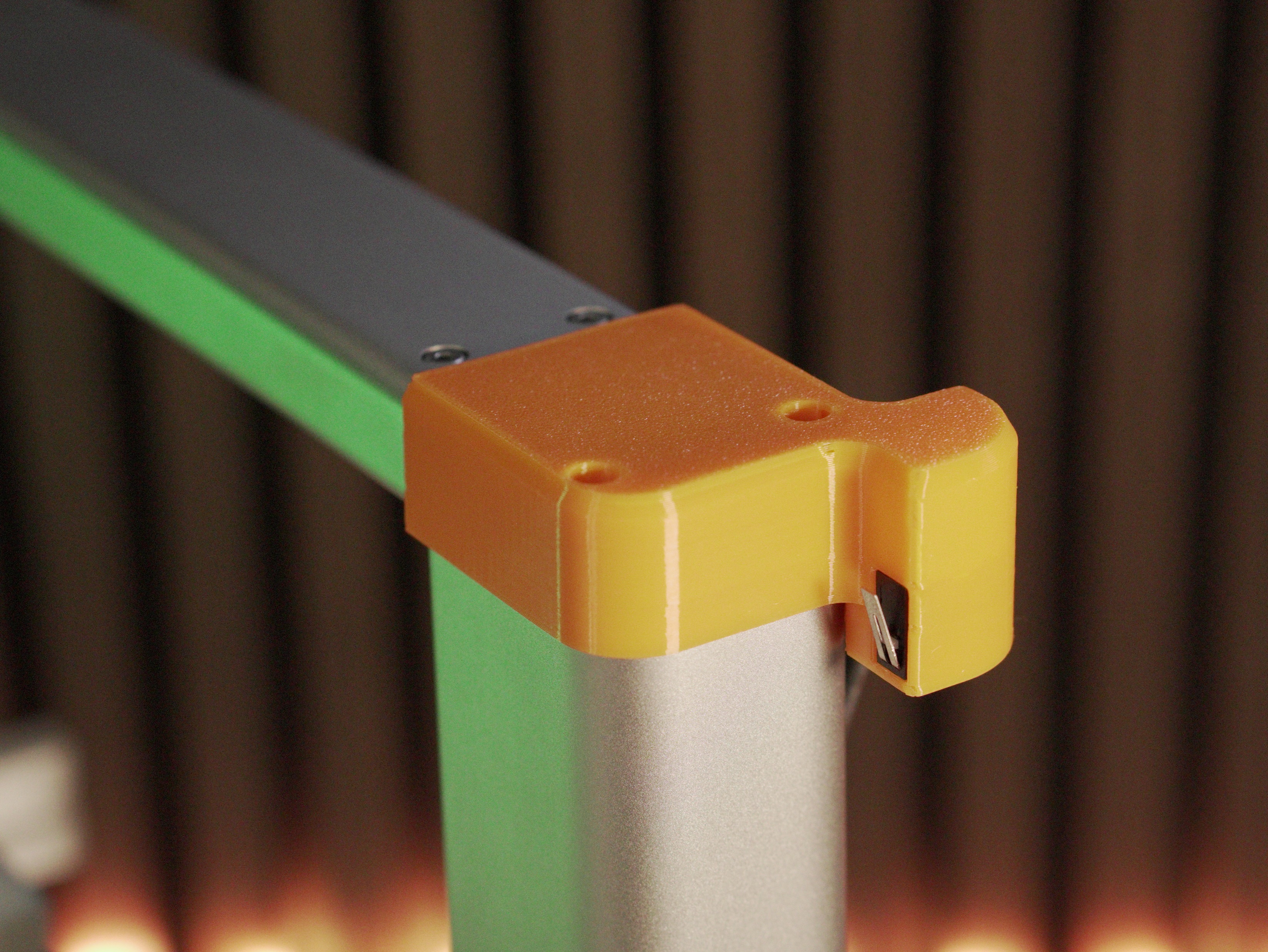 Orange limit-switch assembly mounted on the printer with the two mounting points highlighted