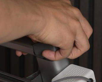 Hand lifting the grey lid off the printer frame