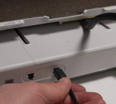 AMS cable plugged into one of the two ports on the back of the printer