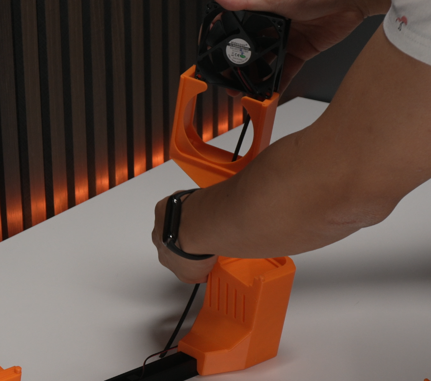 Fan cable routed through opening