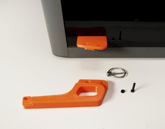 Front hinge bracket mounted on the door, lid arm and quick-release pin laid out ready to attach