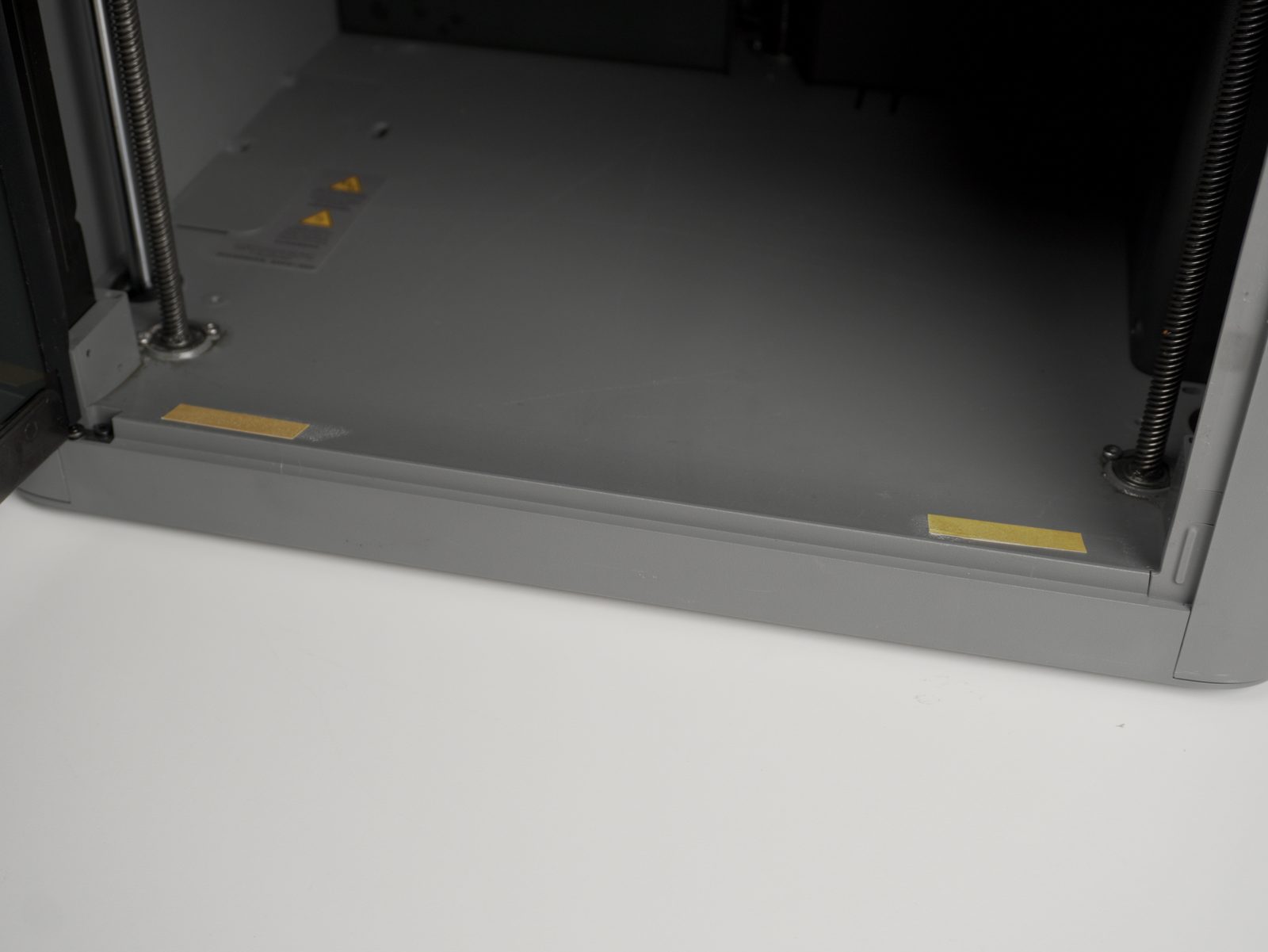Double-sided tape applied to the printer frame