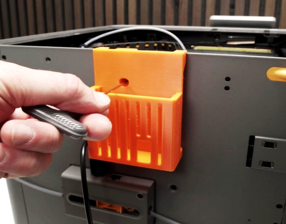 PCB basket being screwed onto the back of the printer