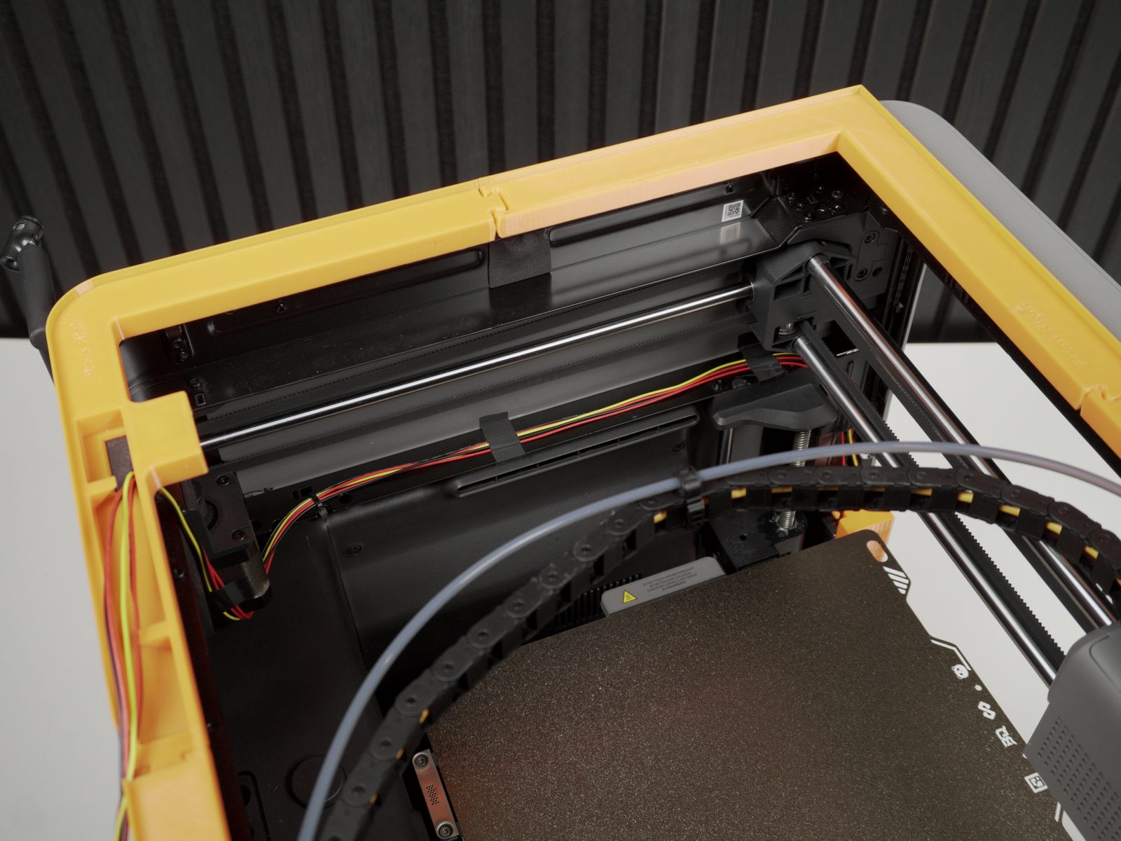 Top-down view of the printer interior with arrows showing the cable routing path