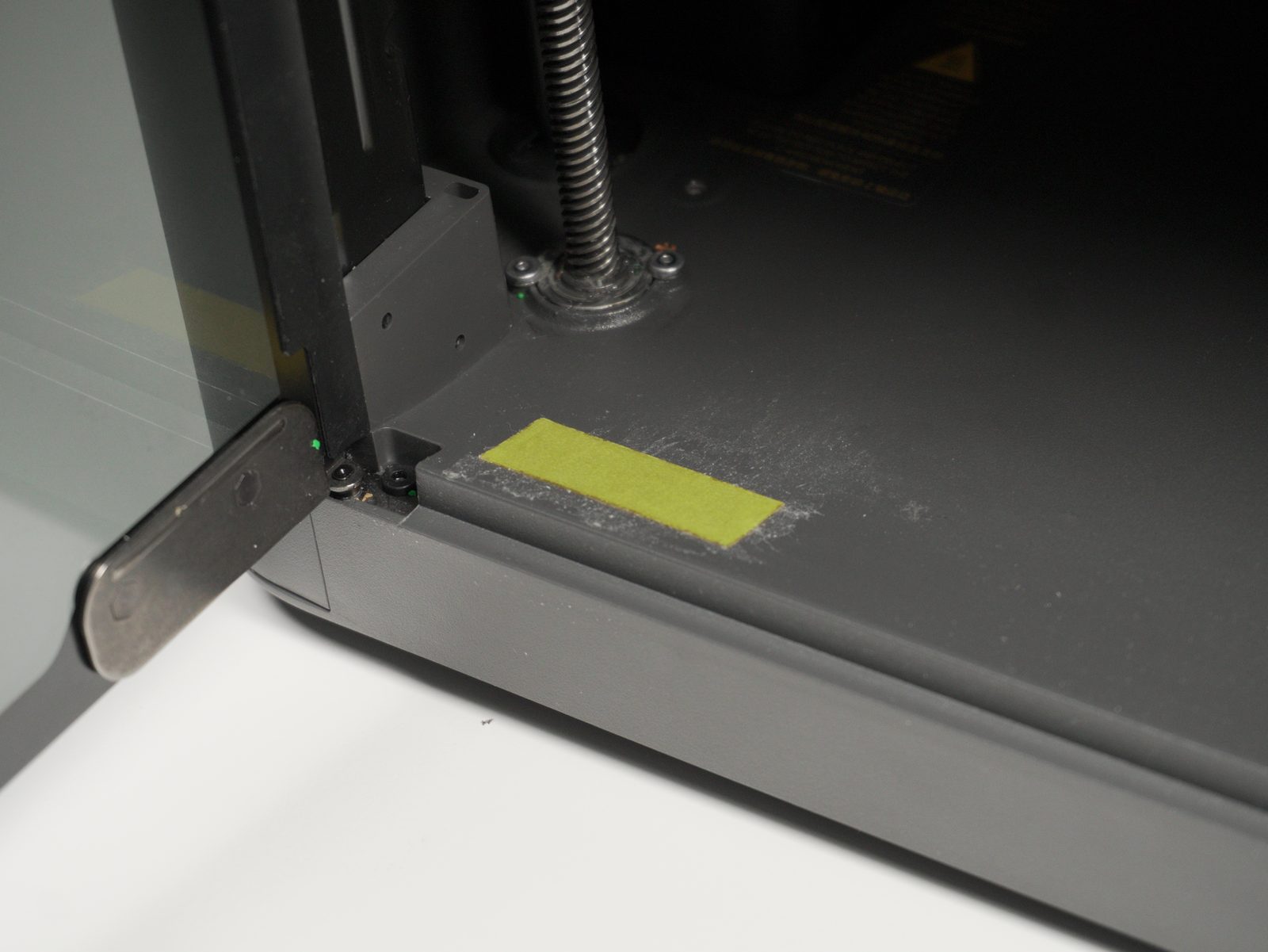 Double-sided tape applied inside the printer chamber