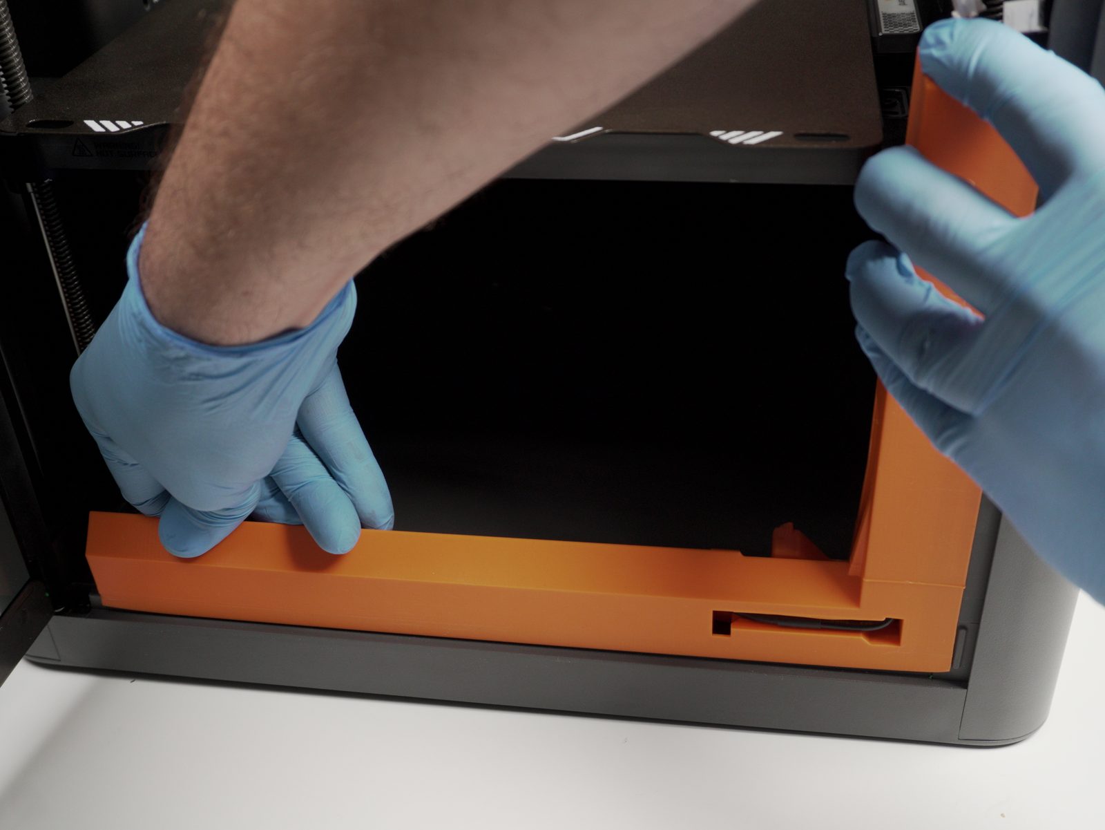 Bender assembly pressed into place inside the printer chamber