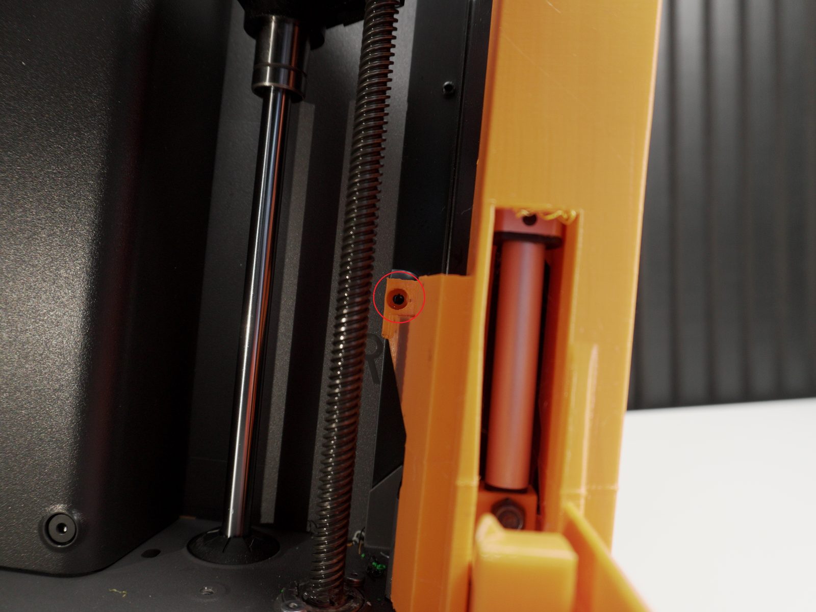 Bender assembly seated against the same screw mount point, circled in red