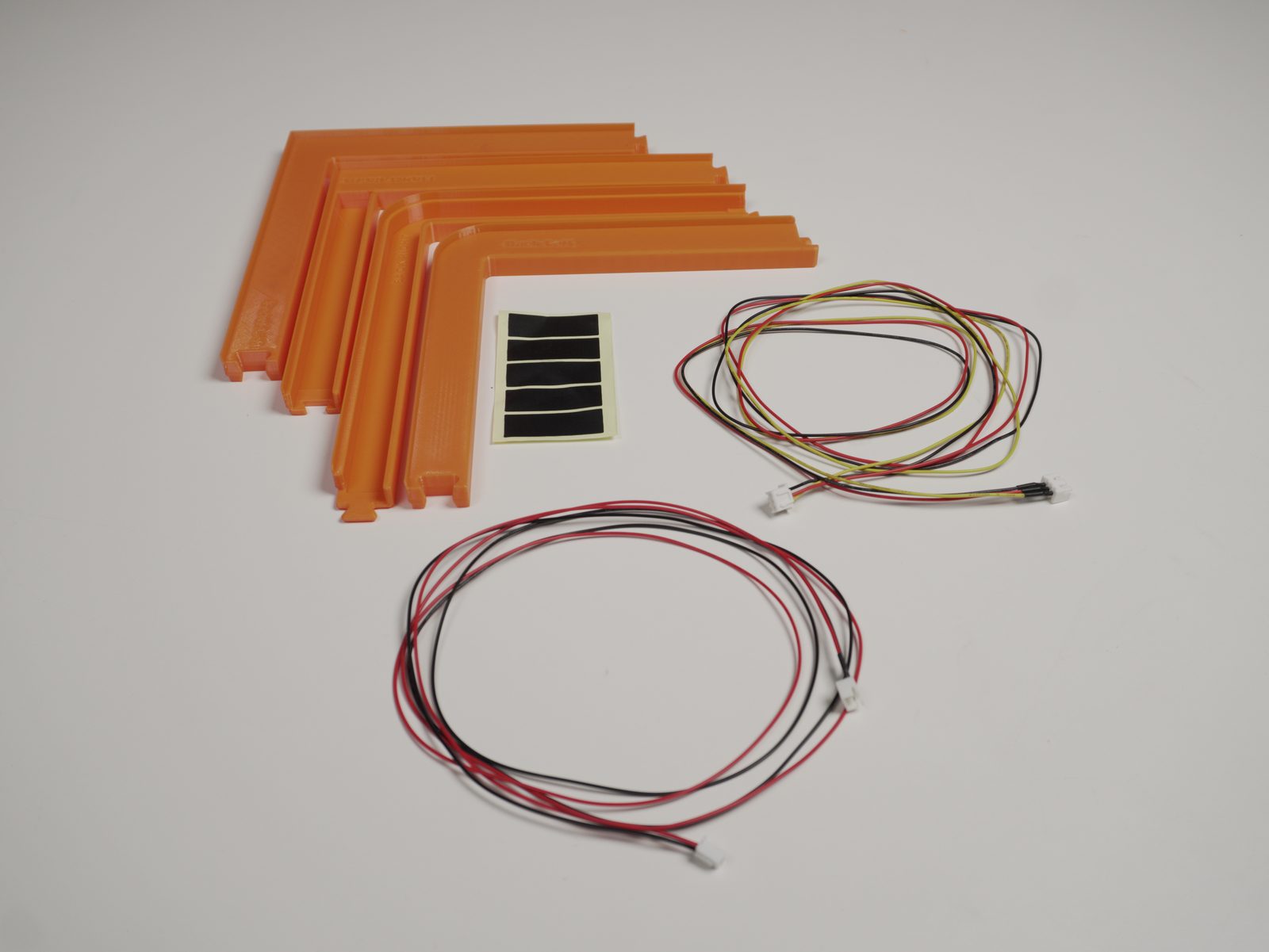 Lid-lifter parts and wire harnesses laid out for the wire-routing step