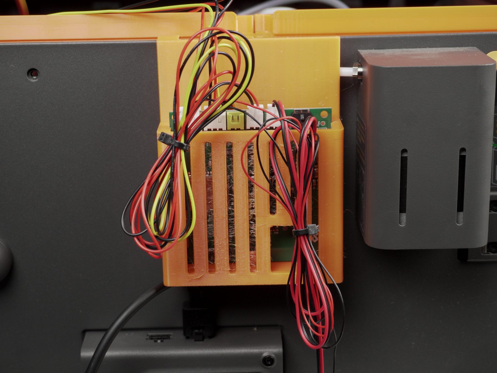 Power-supply cable secured with a self-adhesive clip near the printer foot