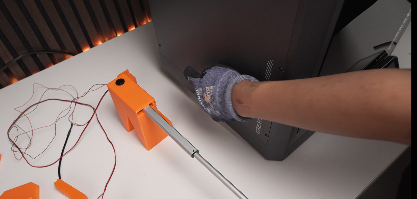 Lifting the printer slightly to position the actuator-holder foot