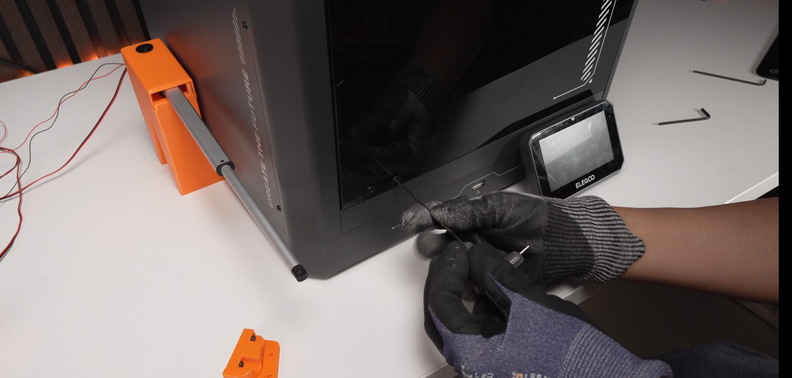 Removing the bottom two screws from the original door hinge