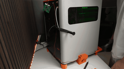 Top screw of the back panel reinserted through the PCB holder