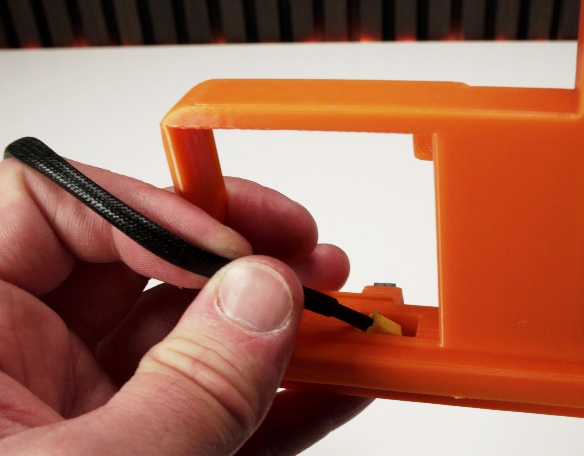 Limit-switch cable held ready near the base of the holder