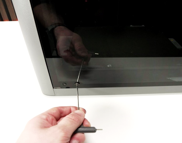 Removing the bottom hinge screws from the front door