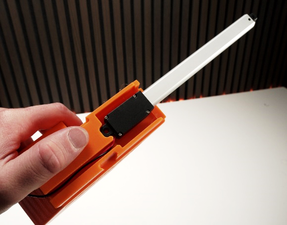 Door actuator held in hand, side view