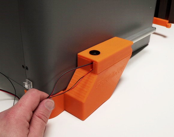 Door actuator seated alongside the printer, rear view