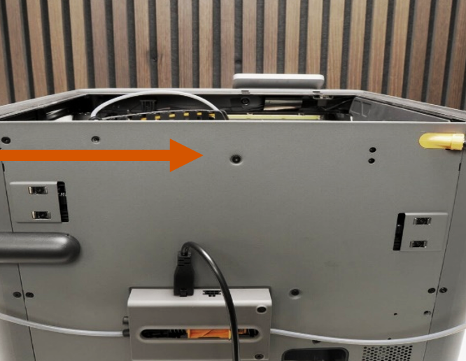 Back-of-printer view with an arrow pointing to the mounting screw hole