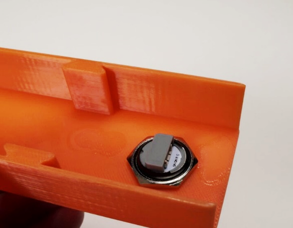 Button assembly viewed from below, secured with the rubber ring and metal ring