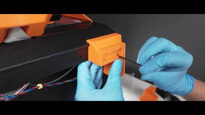 Screwing a tilted foot onto the printer
