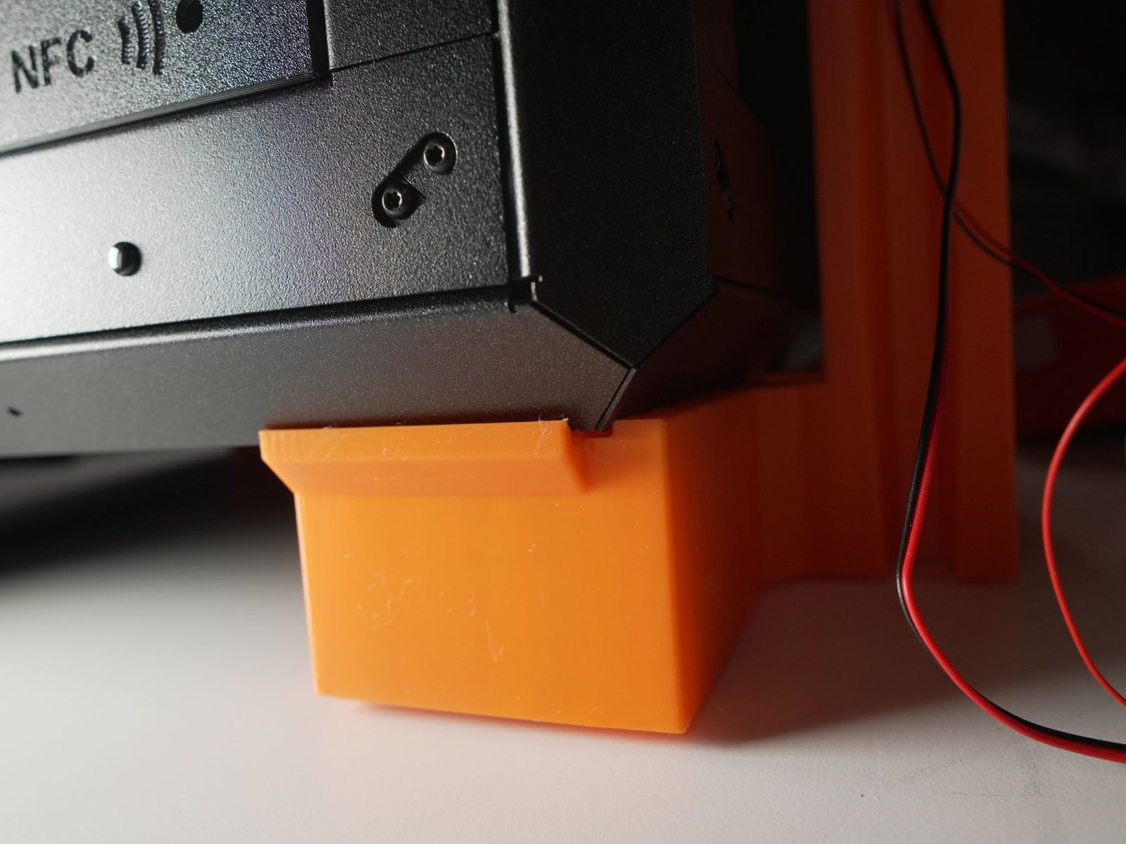 Printer lifted slightly to position the actuator-holder foot correctly