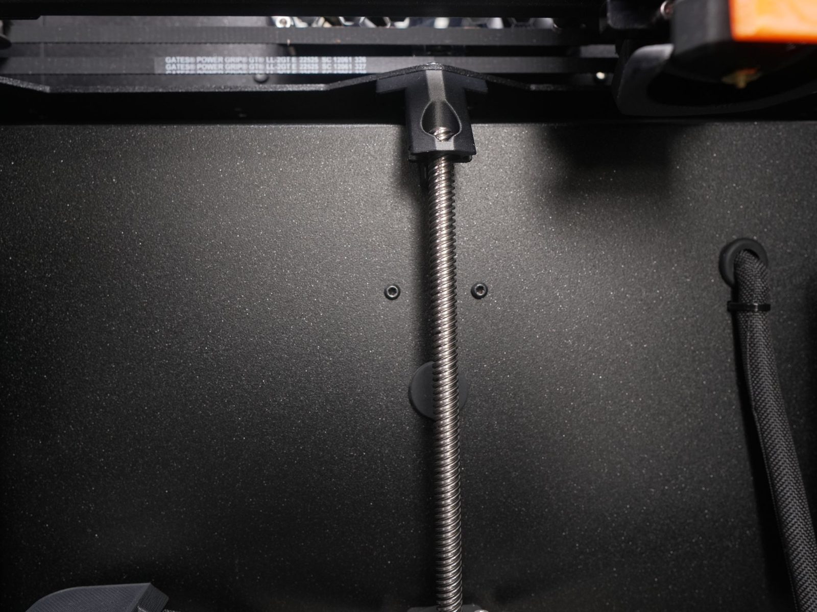 Unscrewing the two bolts in the chamber for the back cable cover