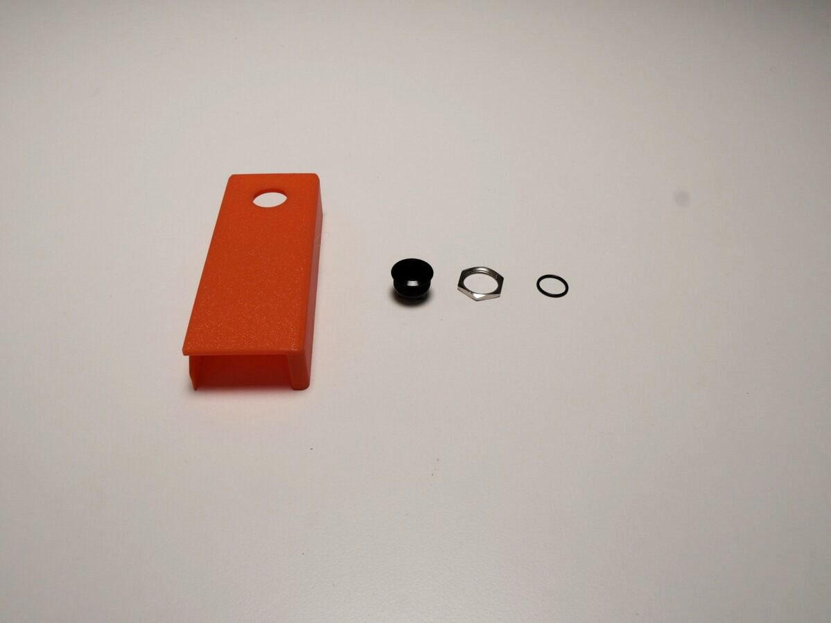 Door-opener button, rubber ring, and metal ring laid out